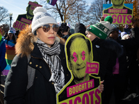 Demonstrators displays signs accusing Supreme Court Justices Samuel Alito and Neil Gorsuch, as well as Chief Justice John Roberts of corrupt...