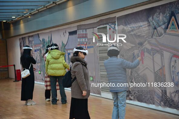 Visitors wear MR Glasses during an immersive interactive exhibition at the Capital Museum in Beijing, China, on December 5, 2024. 