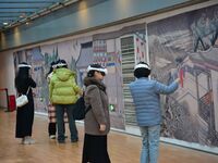 Visitors wear MR Glasses during an immersive interactive exhibition at the Capital Museum in Beijing, China, on December 5, 2024. (