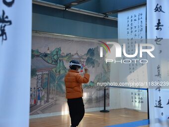 Visitors wear MR Glasses during an immersive interactive exhibition at the Capital Museum in Beijing, China, on December 5, 2024. (