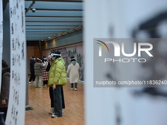 Visitors wear MR Glasses during an immersive interactive exhibition at the Capital Museum in Beijing, China, on December 5, 2024. (