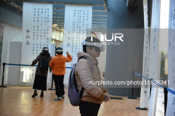 Visitors wear MR Glasses during an immersive interactive exhibition at the Capital Museum in Beijing, China, on December 5, 2024. 