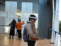 Visitors wear MR Glasses during an immersive interactive exhibition at the Capital Museum in Beijing, China, on December 5, 2024. (