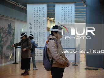 Visitors wear MR Glasses during an immersive interactive exhibition at the Capital Museum in Beijing, China, on December 5, 2024. (