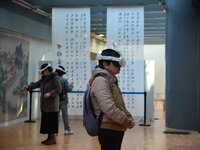 Visitors wear MR Glasses during an immersive interactive exhibition at the Capital Museum in Beijing, China, on December 5, 2024. (