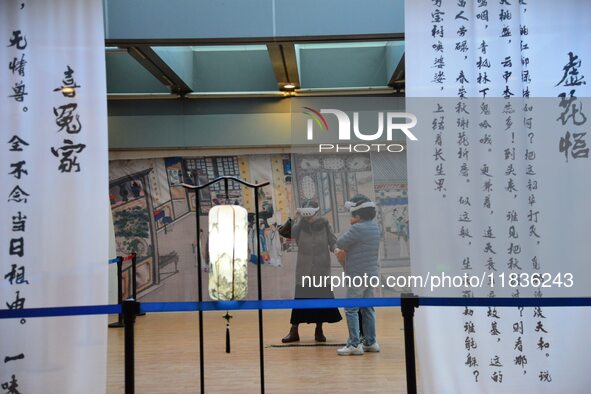 Visitors wear MR Glasses during an immersive interactive exhibition at the Capital Museum in Beijing, China, on December 5, 2024. 