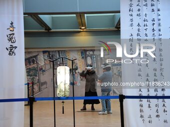 Visitors wear MR Glasses during an immersive interactive exhibition at the Capital Museum in Beijing, China, on December 5, 2024. (