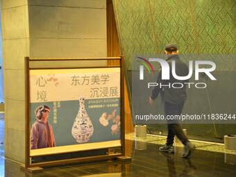 Visitors wear MR Glasses during an immersive interactive exhibition at the Capital Museum in Beijing, China, on December 5, 2024. (