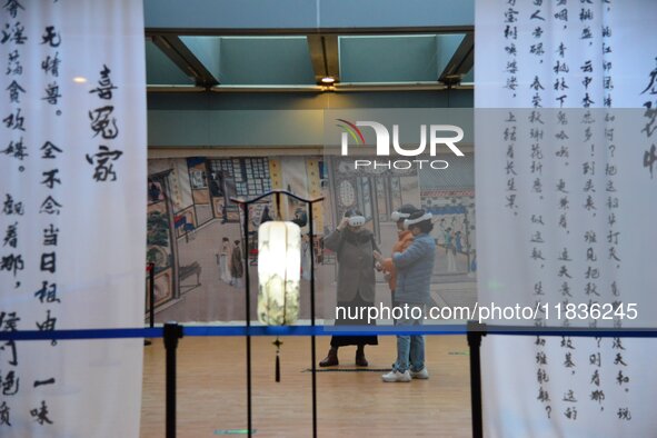 Visitors wear MR Glasses during an immersive interactive exhibition at the Capital Museum in Beijing, China, on December 5, 2024. 