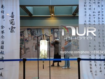 Visitors wear MR Glasses during an immersive interactive exhibition at the Capital Museum in Beijing, China, on December 5, 2024. (