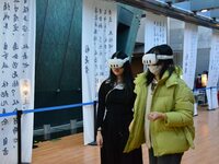 Visitors wear MR Glasses during an immersive interactive exhibition at the Capital Museum in Beijing, China, on December 5, 2024. (