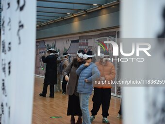 Visitors wear MR Glasses during an immersive interactive exhibition at the Capital Museum in Beijing, China, on December 5, 2024. (