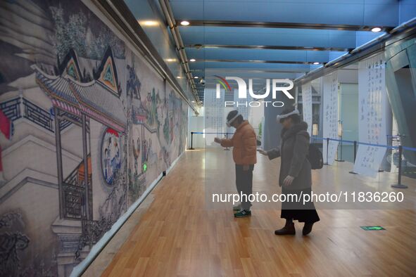 Visitors wear MR Glasses during an immersive interactive exhibition at the Capital Museum in Beijing, China, on December 5, 2024. 