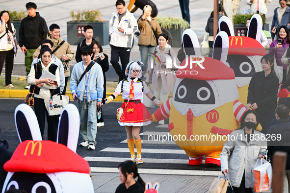 Products from the collaboration between the game Zenless Zone Zero and McDonald's parade through the streets in Shanghai, China, on December...