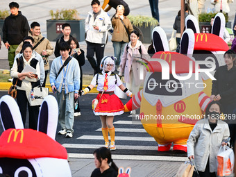 Products from the collaboration between the game Zenless Zone Zero and McDonald's parade through the streets in Shanghai, China, on December...