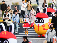 Products from the collaboration between the game Zenless Zone Zero and McDonald's parade through the streets in Shanghai, China, on December...