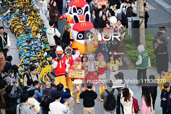 Products from the collaboration between the game Zenless Zone Zero and McDonald's parade through the streets in Shanghai, China, on December...