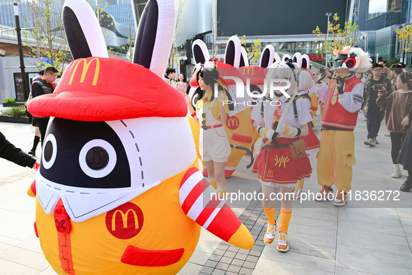 Products from the collaboration between the game Zenless Zone Zero and McDonald's parade through the streets in Shanghai, China, on December...