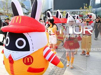 Products from the collaboration between the game Zenless Zone Zero and McDonald's parade through the streets in Shanghai, China, on December...