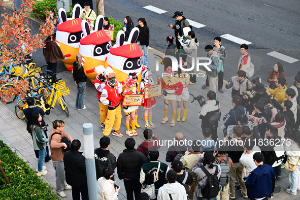 Products from the collaboration between the game Zenless Zone Zero and McDonald's parade through the streets in Shanghai, China, on December...