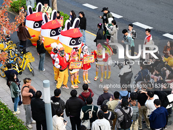 Products from the collaboration between the game Zenless Zone Zero and McDonald's parade through the streets in Shanghai, China, on December...