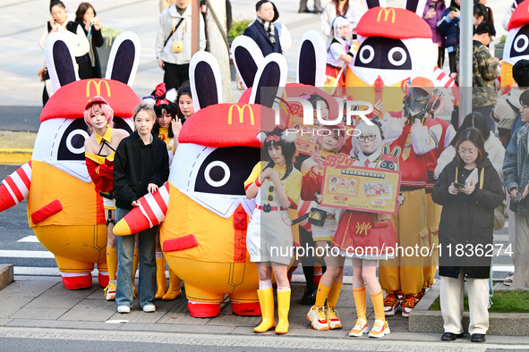 Products from the collaboration between the game Zenless Zone Zero and McDonald's parade through the streets in Shanghai, China, on December...