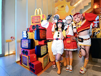 Products from the collaboration between the game Zenless Zone Zero and McDonald's parade through the streets in Shanghai, China, on December...