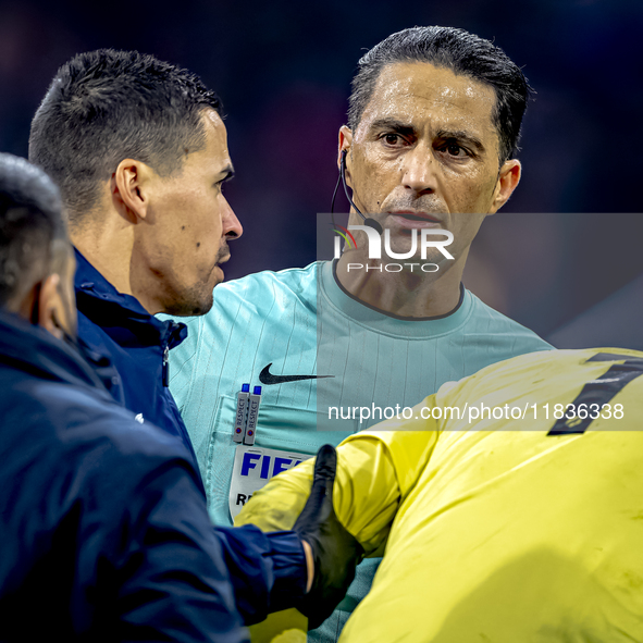 Referee Serdar Gozubuyuk officiates the match between Ajax and Utrecht at the Johan Cruijff ArenA for the Dutch Eredivisie season 2024-2025...