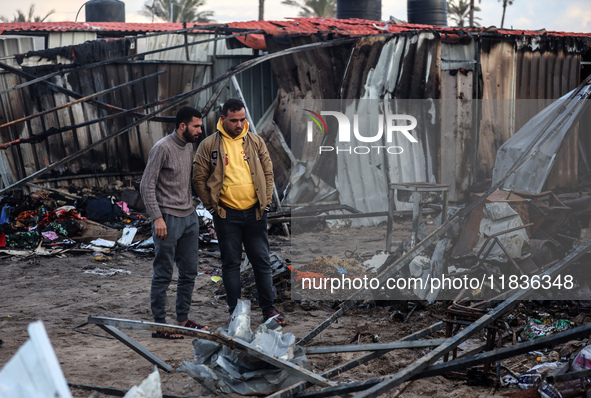 Palestinians inspect the damage in the aftermath of an Israeli strike on a tent camp in Khan Younis, Gaza Strip, on December 5, 2024, amid t...