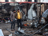 Palestinians inspect the damage in the aftermath of an Israeli strike on a tent camp in Khan Younis, Gaza Strip, on December 5, 2024, amid t...