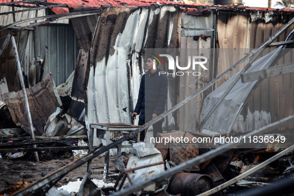 A Palestinian man inspects the damage in the aftermath of an Israeli strike on a tent camp in Khan Younis, Gaza Strip, on December 5, 2024,...