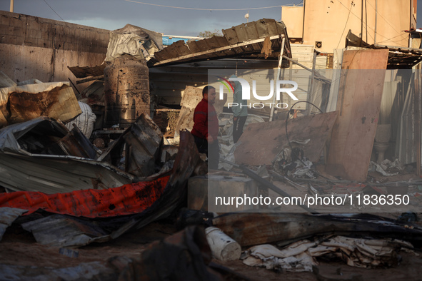 Palestinians inspect the damage in the aftermath of an Israeli strike on a tent camp in Khan Younis, Gaza Strip, on December 5, 2024, amid t...