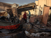 Palestinians inspect the damage in the aftermath of an Israeli strike on a tent camp in Khan Younis, Gaza Strip, on December 5, 2024, amid t...