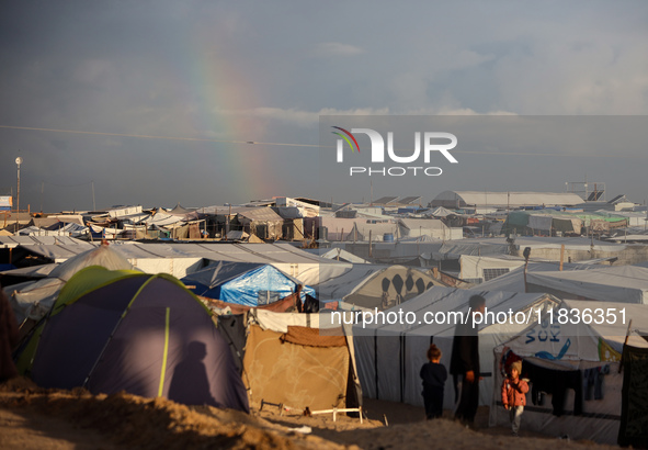 A rainbow appears over a makeshift camp in Khan Younis, Gaza Strip, on December 5, 2024, amid the ongoing war between Israel and Hamas milit...