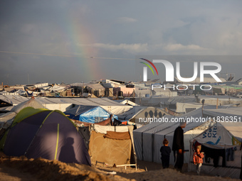 A rainbow appears over a makeshift camp in Khan Younis, Gaza Strip, on December 5, 2024, amid the ongoing war between Israel and Hamas milit...