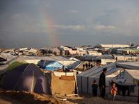 A rainbow appears over a makeshift camp in Khan Younis, Gaza Strip, on December 5, 2024, amid the ongoing war between Israel and Hamas milit...