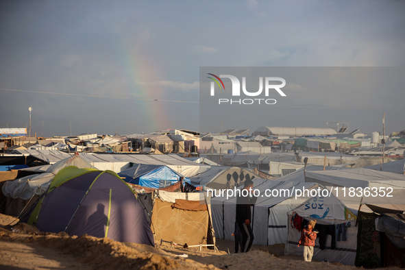 A rainbow appears over a makeshift camp in Khan Younis, Gaza Strip, on December 5, 2024, amid the ongoing war between Israel and Hamas milit...