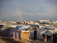 A rainbow appears over a makeshift camp in Khan Younis, Gaza Strip, on December 5, 2024, amid the ongoing war between Israel and Hamas milit...