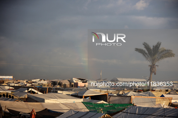 A rainbow appears over a makeshift camp in Khan Younis, Gaza Strip, on December 5, 2024, amid the ongoing war between Israel and Hamas milit...