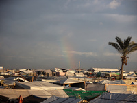 A rainbow appears over a makeshift camp in Khan Younis, Gaza Strip, on December 5, 2024, amid the ongoing war between Israel and Hamas milit...