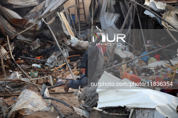 A Palestinian man inspects the damage in the aftermath of an Israeli strike on a tent camp in Khan Younis, Gaza Strip, on December 5, 2024,...