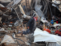 A Palestinian man inspects the damage in the aftermath of an Israeli strike on a tent camp in Khan Younis, Gaza Strip, on December 5, 2024,...