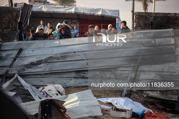 Palestinians inspect the damage in the aftermath of an Israeli strike on a tent camp in Khan Younis, Gaza Strip, on December 5, 2024, amid t...