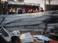 Palestinians inspect the damage in the aftermath of an Israeli strike on a tent camp in Khan Younis, Gaza Strip, on December 5, 2024, amid t...