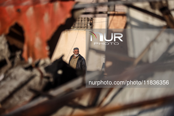 A Palestinian man inspects the damage in the aftermath of an Israeli strike on a tent camp in Khan Younis, Gaza Strip, on December 5, 2024,...