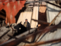 A Palestinian man inspects the damage in the aftermath of an Israeli strike on a tent camp in Khan Younis, Gaza Strip, on December 5, 2024,...