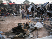 Palestinians inspect the damage in the aftermath of an Israeli strike on a tent camp in Khan Younis, Gaza Strip, on December 5, 2024, amid t...