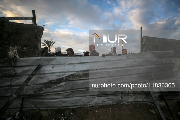 Palestinians inspect the damage in the aftermath of an Israeli strike on a tent camp in Khan Younis, Gaza Strip, on December 5, 2024, amid t...