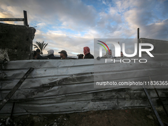 Palestinians inspect the damage in the aftermath of an Israeli strike on a tent camp in Khan Younis, Gaza Strip, on December 5, 2024, amid t...