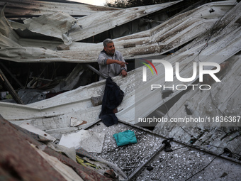 A Palestinian man inspects the damage in the aftermath of an Israeli strike on a tent camp in Khan Younis, Gaza Strip, on December 5, 2024,...